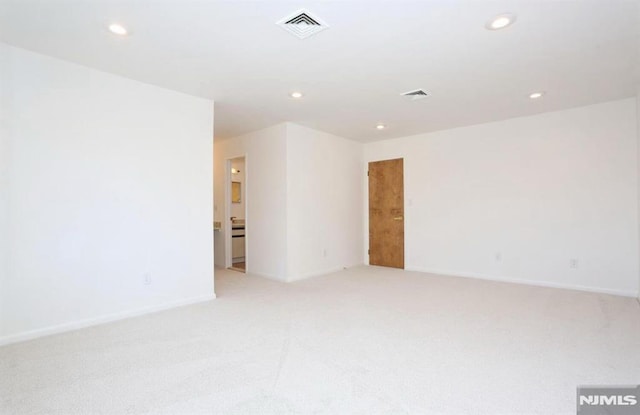 unfurnished room with light carpet