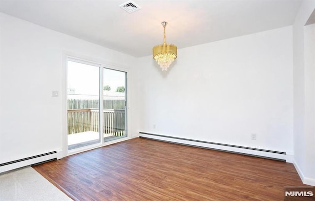 unfurnished room featuring a baseboard heating unit, a notable chandelier, and dark hardwood / wood-style flooring