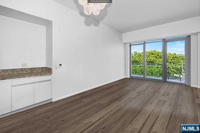 interior space with a chandelier and dark hardwood / wood-style flooring