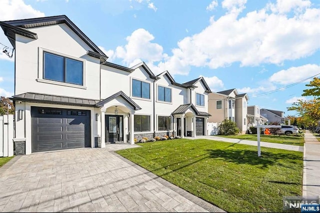 view of front of house featuring a front lawn and a garage