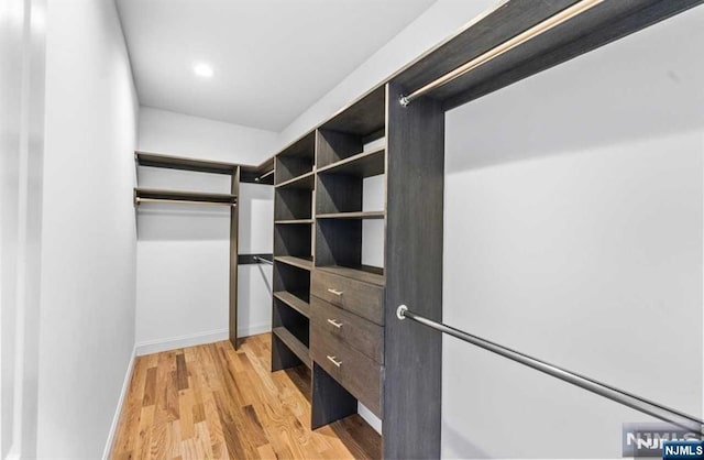 spacious closet with light hardwood / wood-style floors