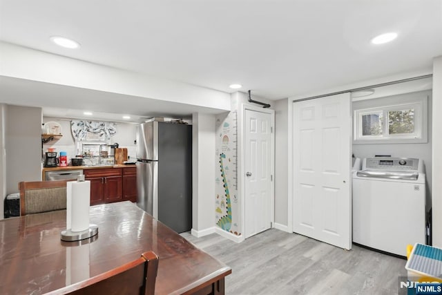 dining room with sink and light hardwood / wood-style floors