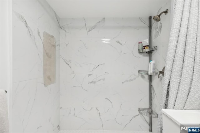 bathroom with a tile shower