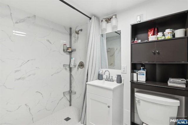 bathroom with vanity, toilet, and walk in shower