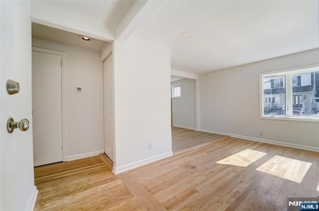 empty room with light hardwood / wood-style floors