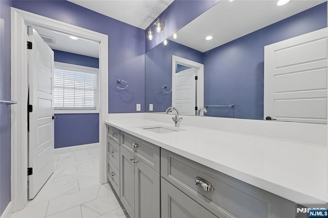 bathroom featuring visible vents, marble finish floor, and vanity