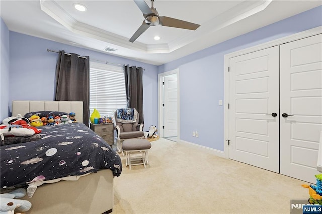 bedroom featuring light carpet, a tray ceiling, crown molding, and recessed lighting