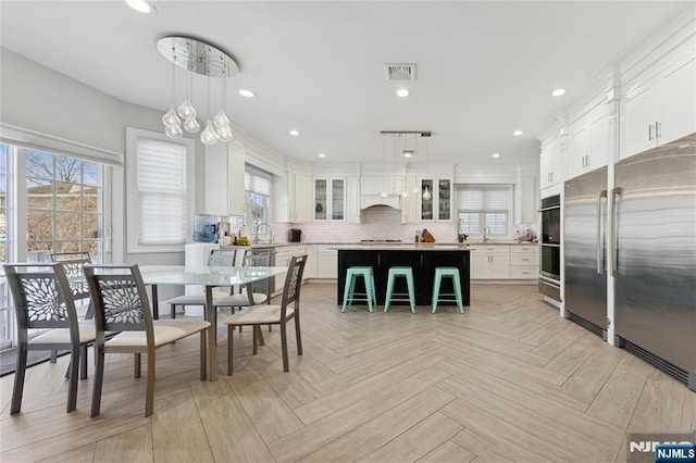 dining area with a wealth of natural light, visible vents, and recessed lighting