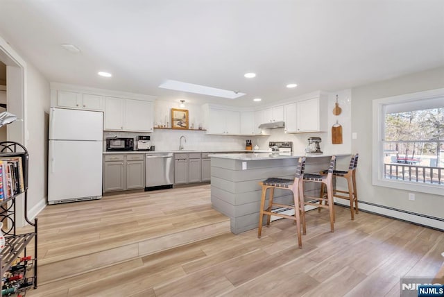 kitchen with range, gray cabinetry, dishwasher, white cabinets, and white fridge