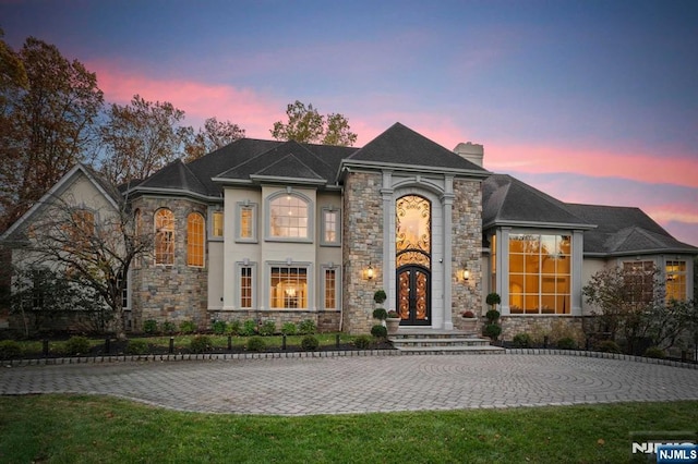 french provincial home featuring a yard