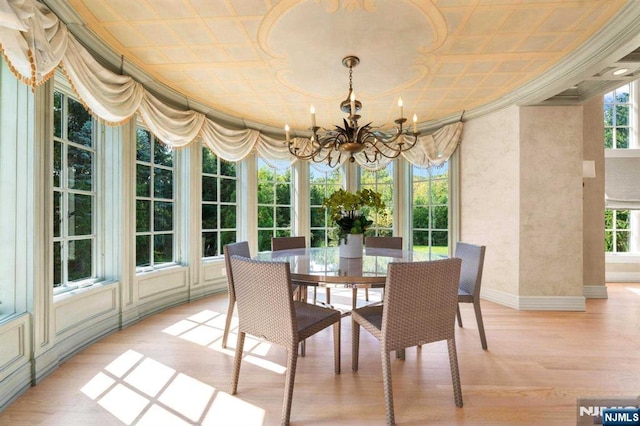 sunroom / solarium with an inviting chandelier