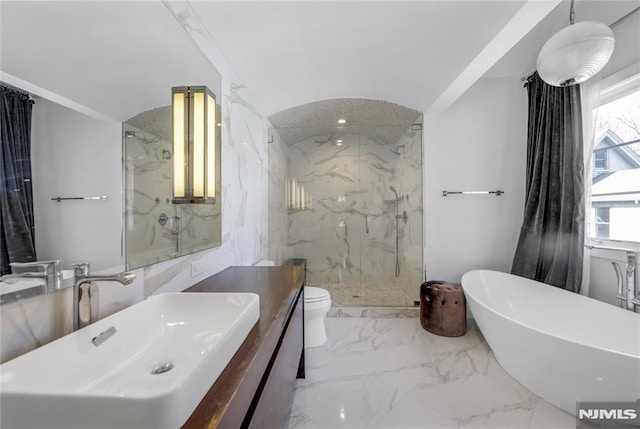 full bath featuring a marble finish shower, toilet, marble finish floor, a freestanding bath, and stone wall