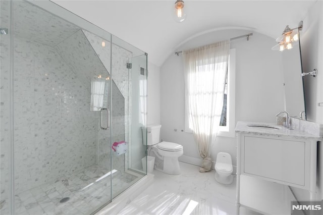 bathroom featuring vanity, marble finish floor, a shower stall, toilet, and vaulted ceiling