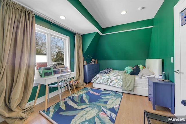 bedroom featuring vaulted ceiling, recessed lighting, and wood finished floors