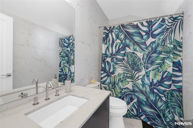 full bath featuring toilet, marble finish floor, a shower with shower curtain, and vanity