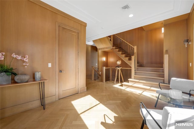 interior space featuring wooden walls, visible vents, and recessed lighting