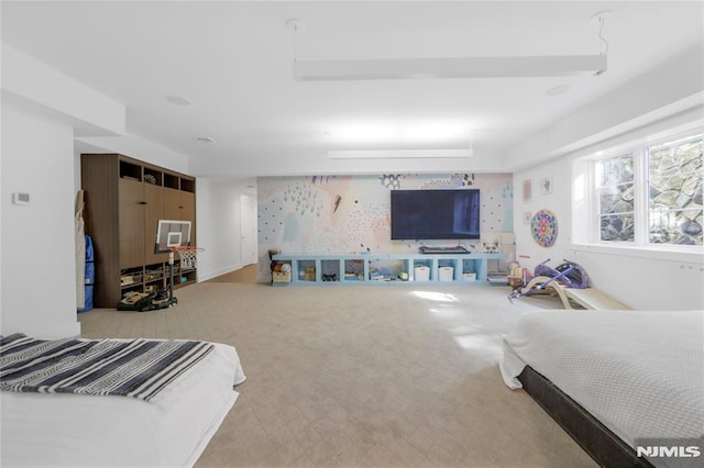 bedroom featuring wallpapered walls, carpet, and an accent wall