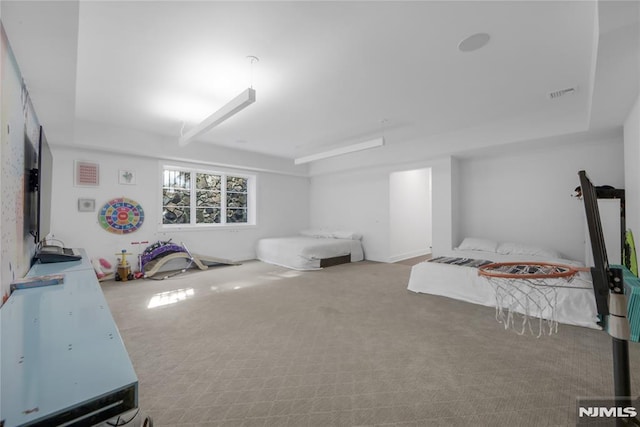 carpeted bedroom featuring visible vents