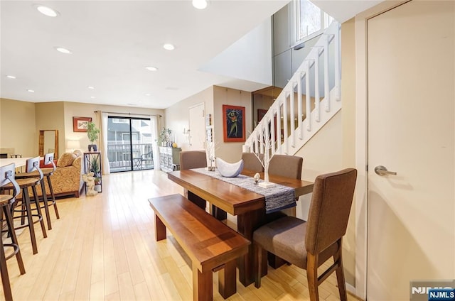 dining area featuring light wood-style floors, stairs, and recessed lighting