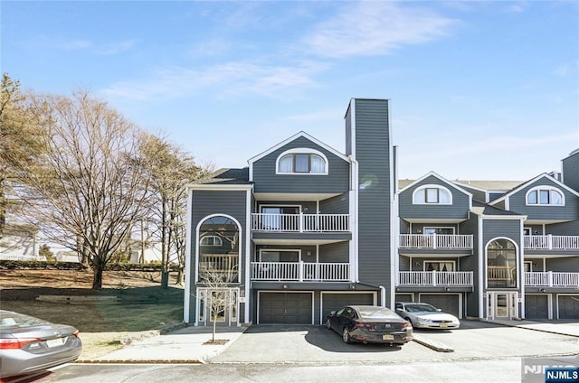 view of building exterior featuring driveway and an attached garage