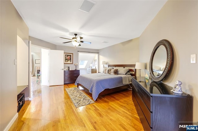 bedroom featuring light wood-style flooring, baseboards, and a ceiling fan