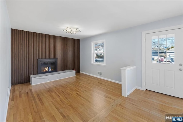 unfurnished living room featuring light hardwood / wood-style floors