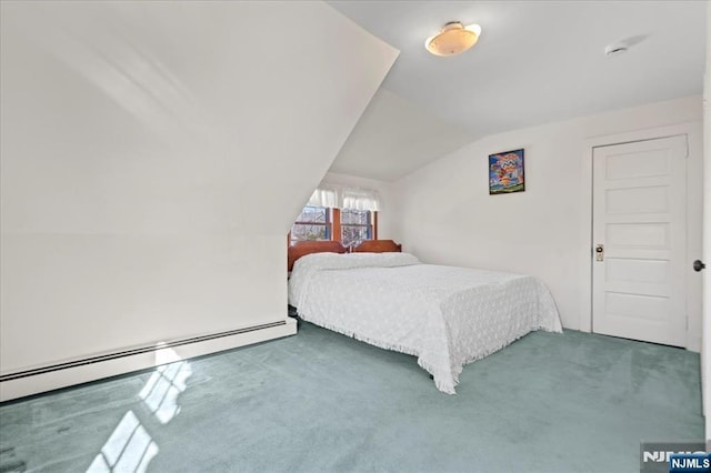 carpeted bedroom featuring a baseboard heating unit and vaulted ceiling