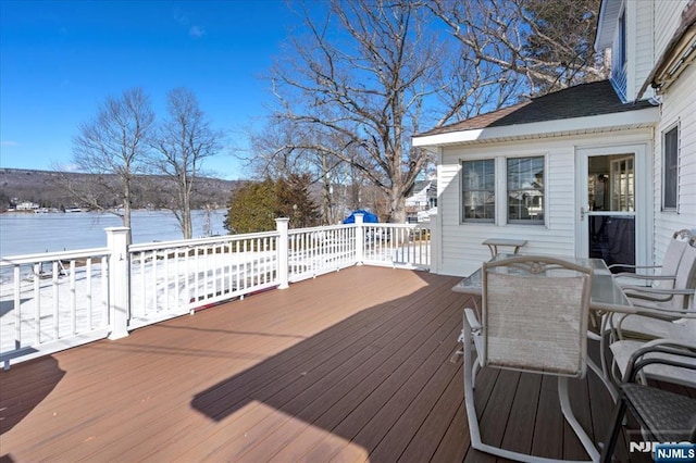 snow covered deck featuring outdoor dining area