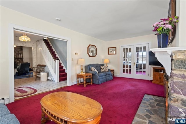 tiled living area with a stone fireplace, french doors, baseboard heating, stairway, and carpet