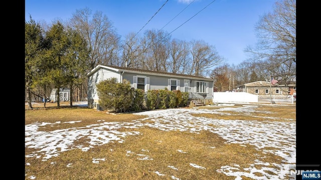 view of snow covered exterior featuring fence