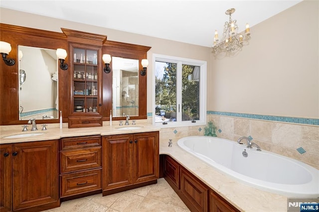 bathroom featuring tile patterned flooring, a sink, and double vanity