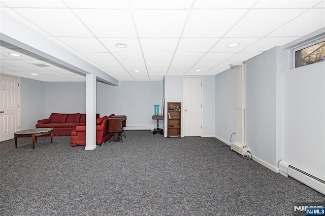 finished basement featuring dark colored carpet, recessed lighting, baseboard heating, a baseboard heating unit, and baseboards