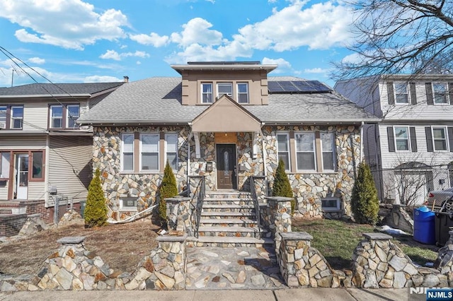 view of front of property featuring solar panels