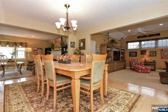 dining space featuring recessed lighting, baseboards, wood-type flooring, and ceiling fan with notable chandelier