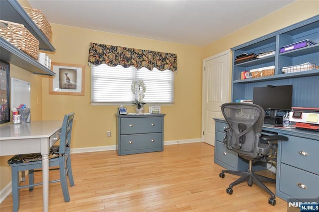 office space featuring light wood-type flooring and baseboards