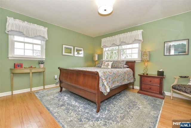 bedroom with wood finished floors and baseboards