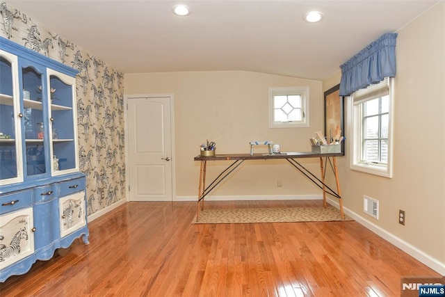 interior space featuring visible vents, baseboards, vaulted ceiling, recessed lighting, and light wood-style flooring