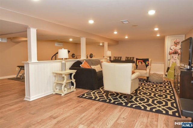 living area featuring recessed lighting, visible vents, and wood finished floors