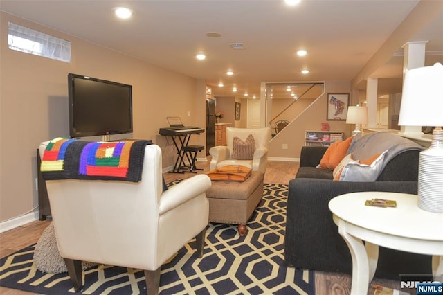 living area with recessed lighting, visible vents, and baseboards