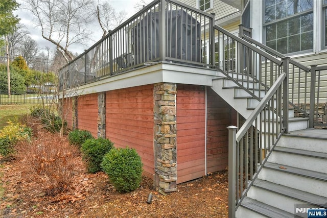 view of side of home featuring stairs