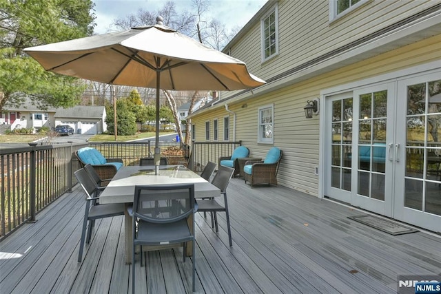 wooden terrace with french doors and outdoor dining space