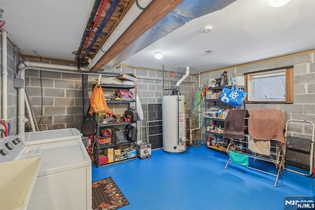 interior space featuring sink, washing machine and clothes dryer, and gas water heater