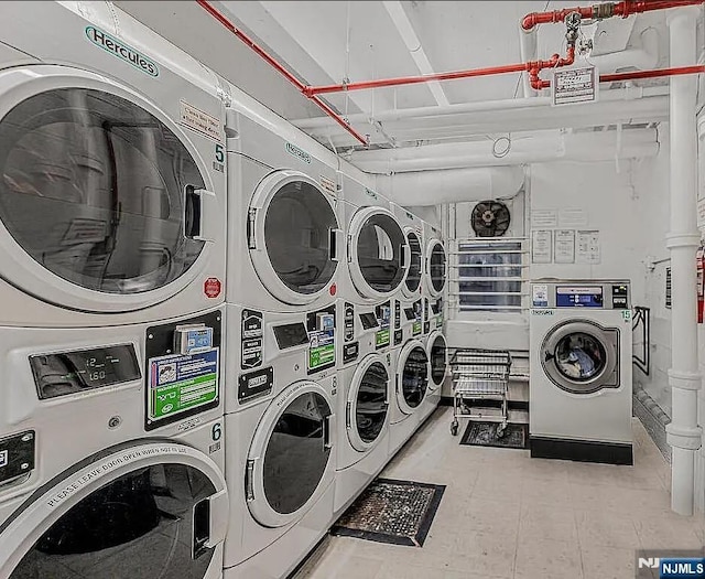 laundry area featuring separate washer and dryer and stacked washer / drying machine