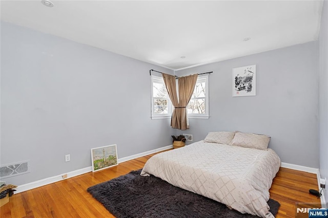 bedroom with hardwood / wood-style floors