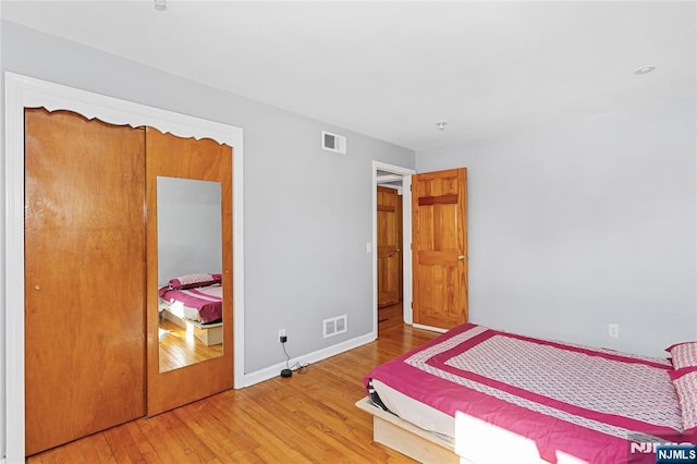 bedroom with hardwood / wood-style floors