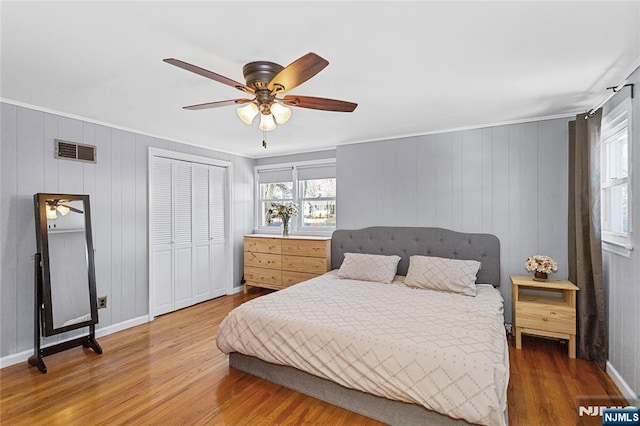 bedroom with hardwood / wood-style flooring, crown molding, and ceiling fan