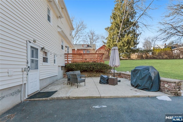 view of patio / terrace featuring a deck and a grill