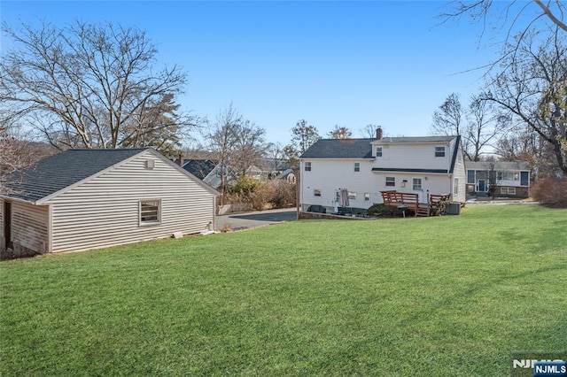 back of house featuring a yard and a wooden deck