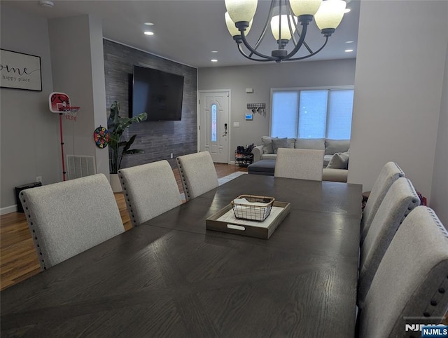 dining space featuring a chandelier and wood-type flooring