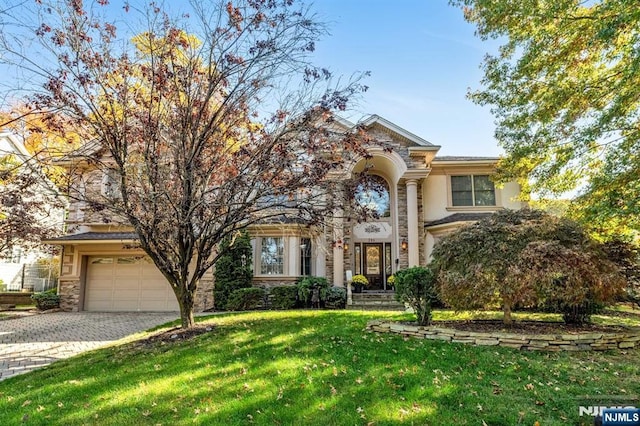 view of front of property with a front yard and a garage